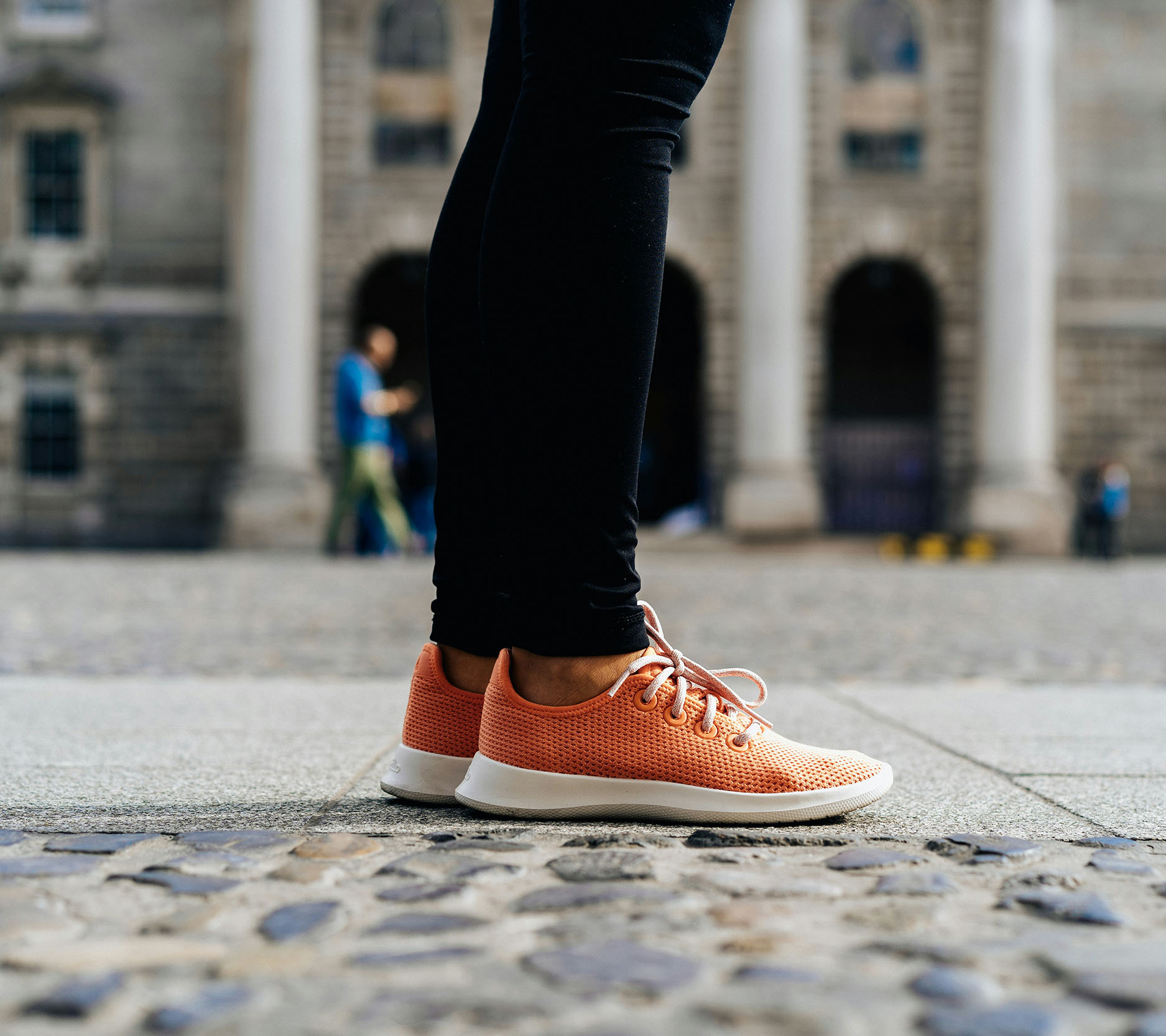 a person standing on the sidewalk with bright orange sneakers with only their legs and feet in view, Sheaff Brock investment advisors blog, retail consumers