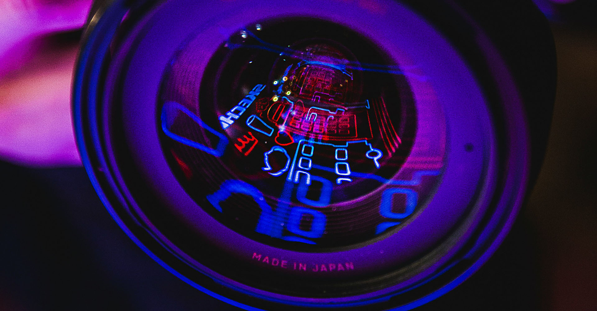 close up of camera lens reflecting neon signs, Sheaff Brock investment advisors blog, retail consumers
