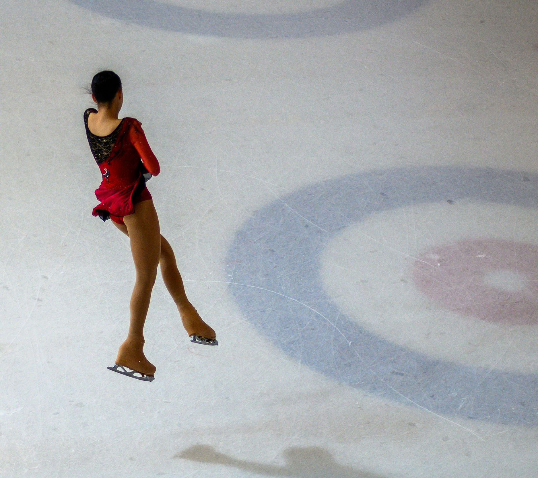 Sheaff Brock in the news, Dave Gilreath publications for Medical Economics, woman figure skater in a red and black dress mid-jump above the ice