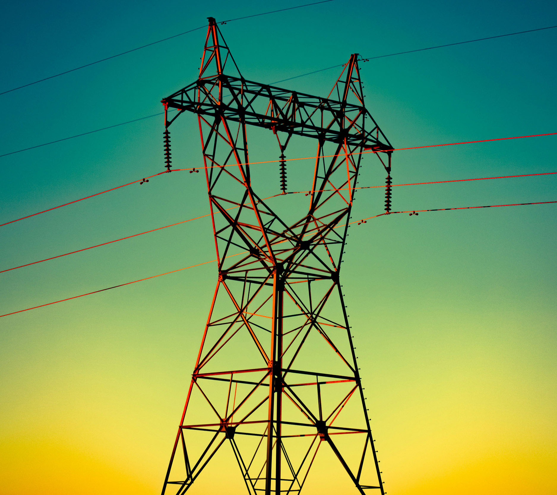 Sheaff Brock in the news, Dave Gilreath publications for Investing.com, utility tower supporting wires at sunset with the sky a gradient starting with orange at the horizon and turning more blue