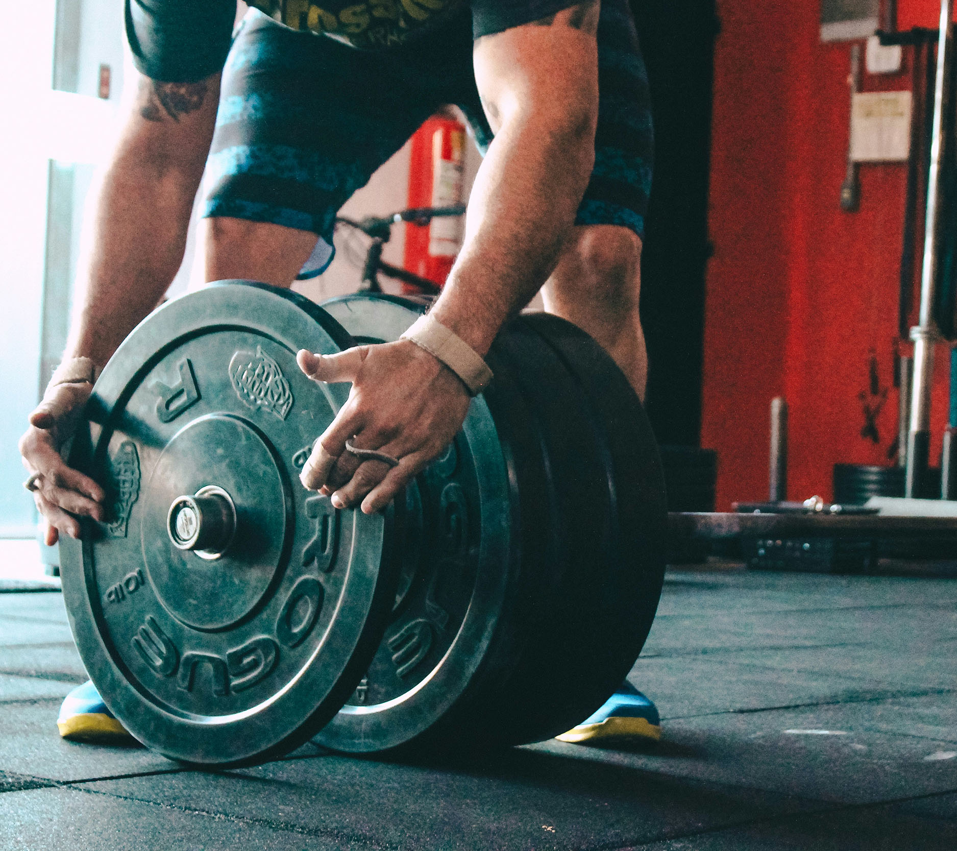 Sheaff Brock in the news, Dave Gilreath publications for Medical Economics, close-up of hands putting a weight on a barbell