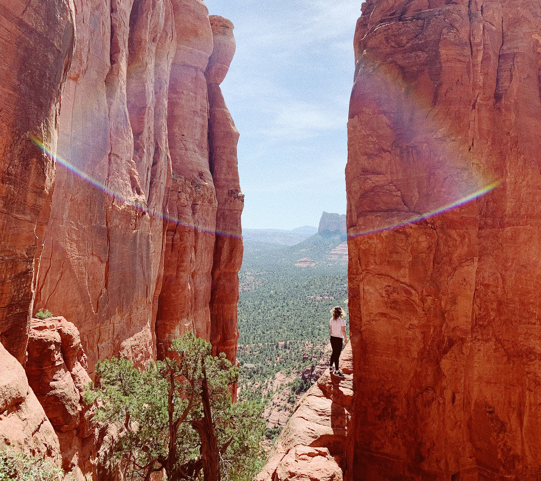 Sheaff Brock in the news, JR Humphreys publications for Benzinga, photo of a woman walking on a narrow path next to red rock cliffs