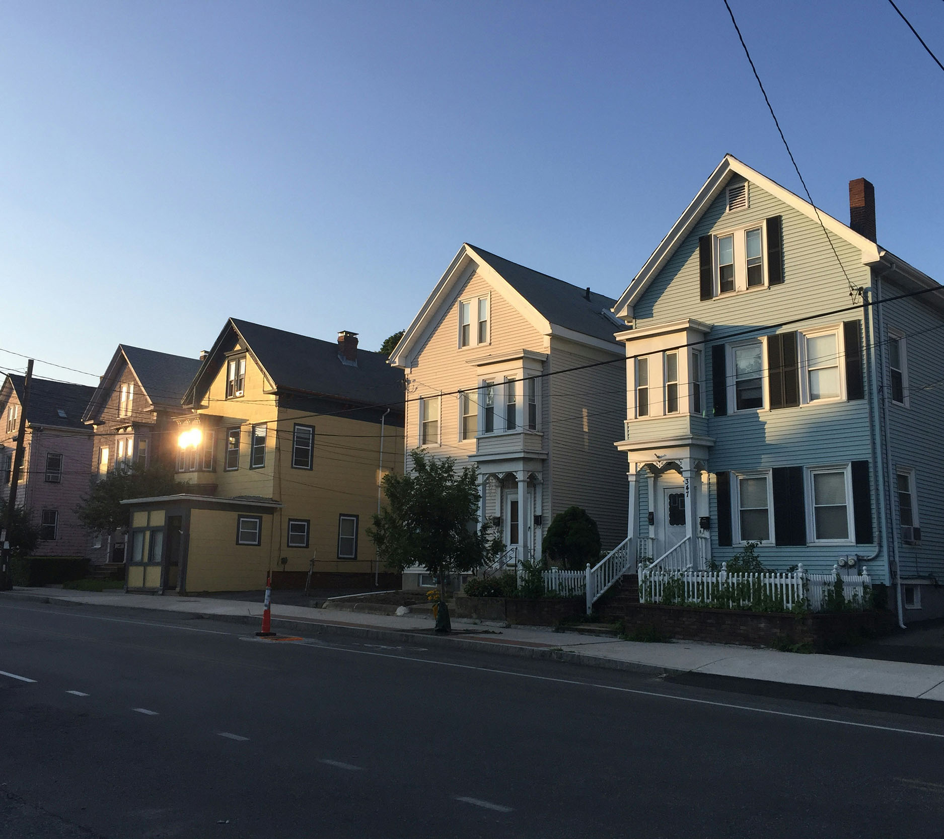 Sheaff Brock in the news, Tom Kaiser & JR Humphreys publications for Medical Economics, row of colorful two-story houses as the sun is rising