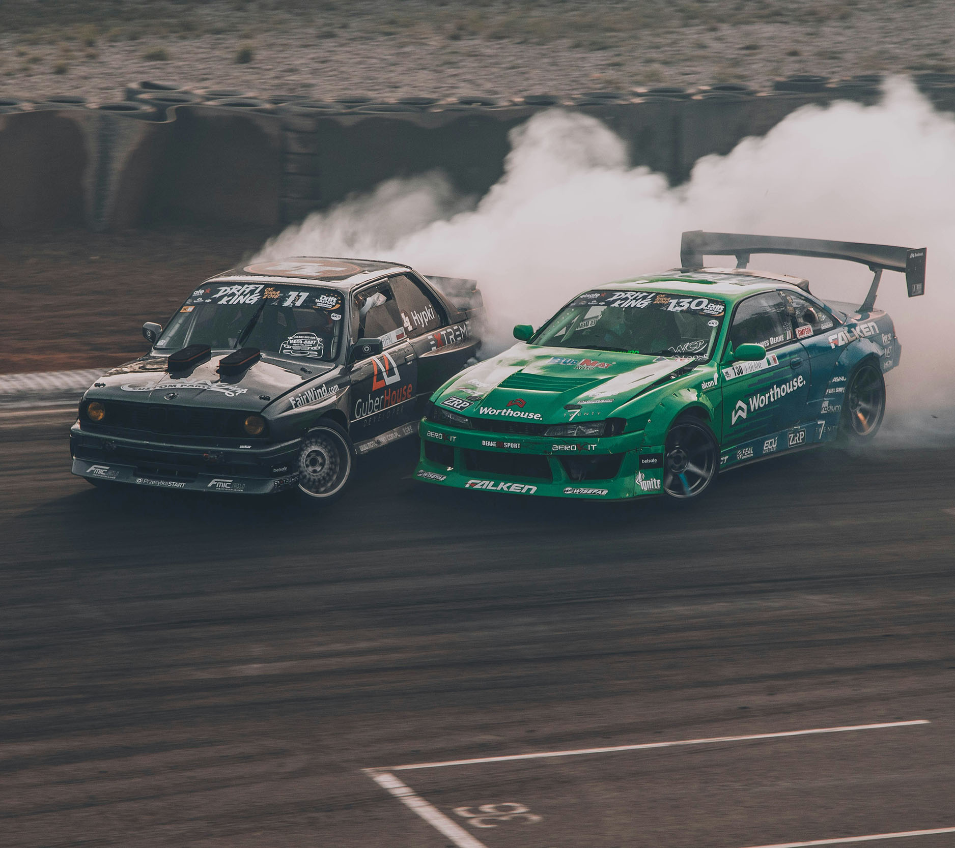 Sheaff Brock market update newsletters, April 2024, black and green racecars driving side by side on a track with smoke behind them